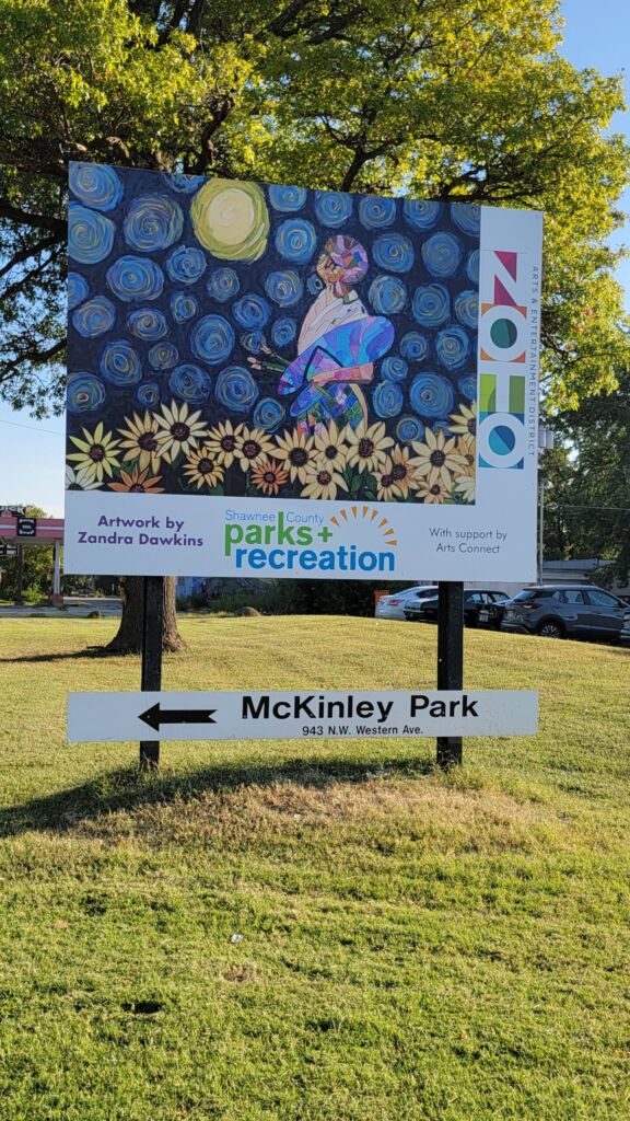 Sign featuring a colorful field of sunflowers.