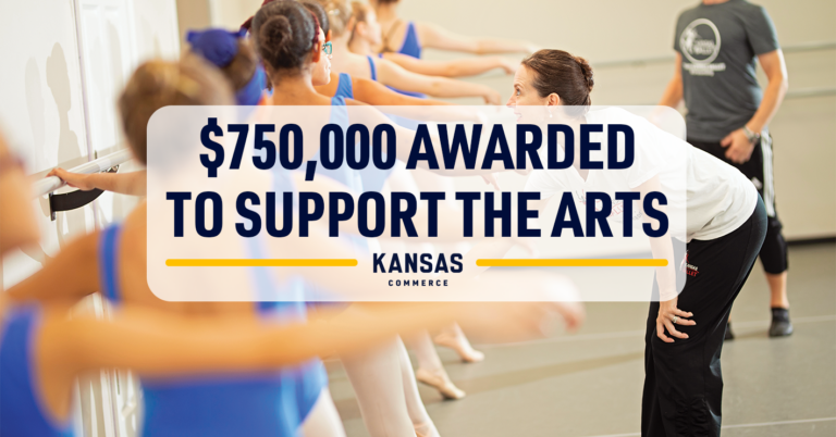 A group of people in blue athletic outfits engage in a dance class, stretching against a barre in a studio. A person in activewear overlooks the group. A large overlay text reads, "$750,000 Awarded to Support the Arts," with "Kansas Commerce" below it.