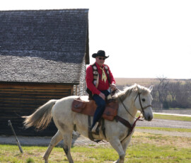 Pony Express rider outside an old station house.