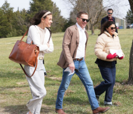 Individuals walk toward the tent.