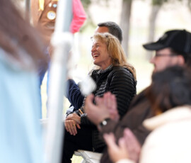 An individual in the crowd laughs.