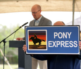 The new Pony Express Byway sign is held up.