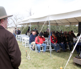 An individual in hat observes the crowd at the Pony Express Byway dedication event.