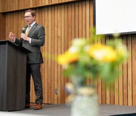 Individual on stage at the HEAL 6.0 award presentation.
